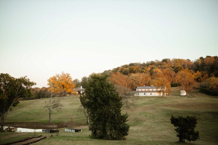 view of the altar with a barn and house on a hill