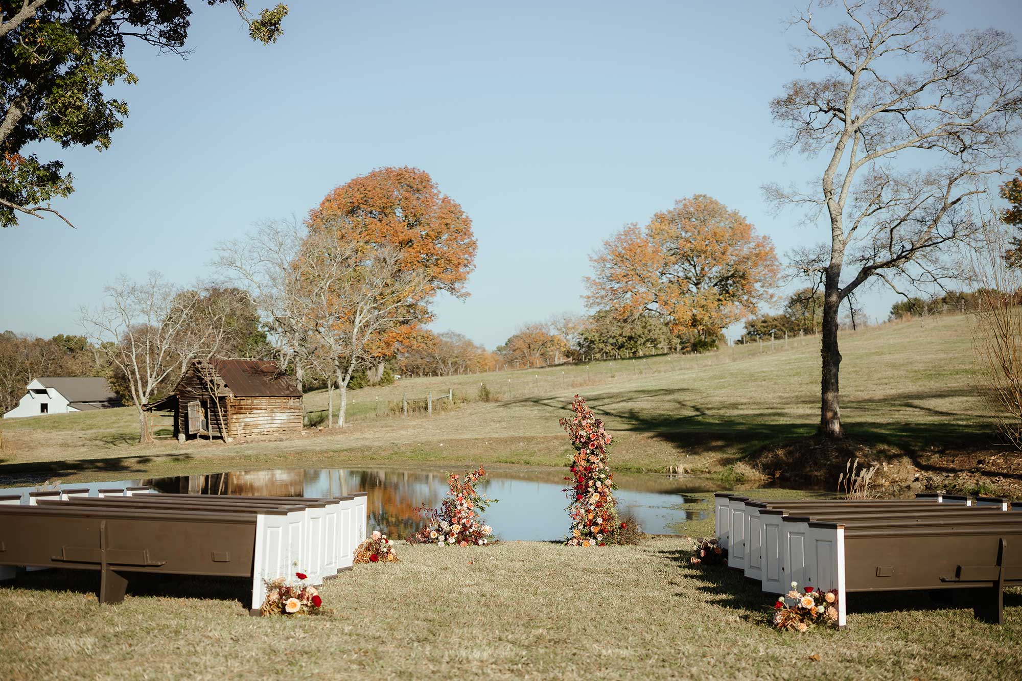 The altar outside decorated with flower and the lake behind it.