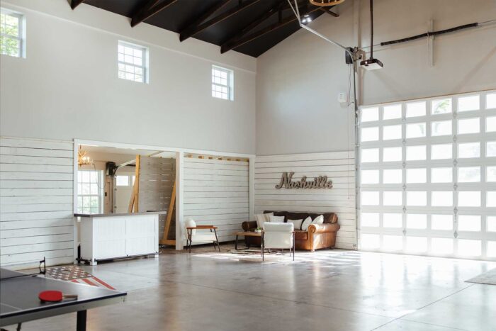 gathering area in the barn with ping pong, basketball and corn hole and a seating area